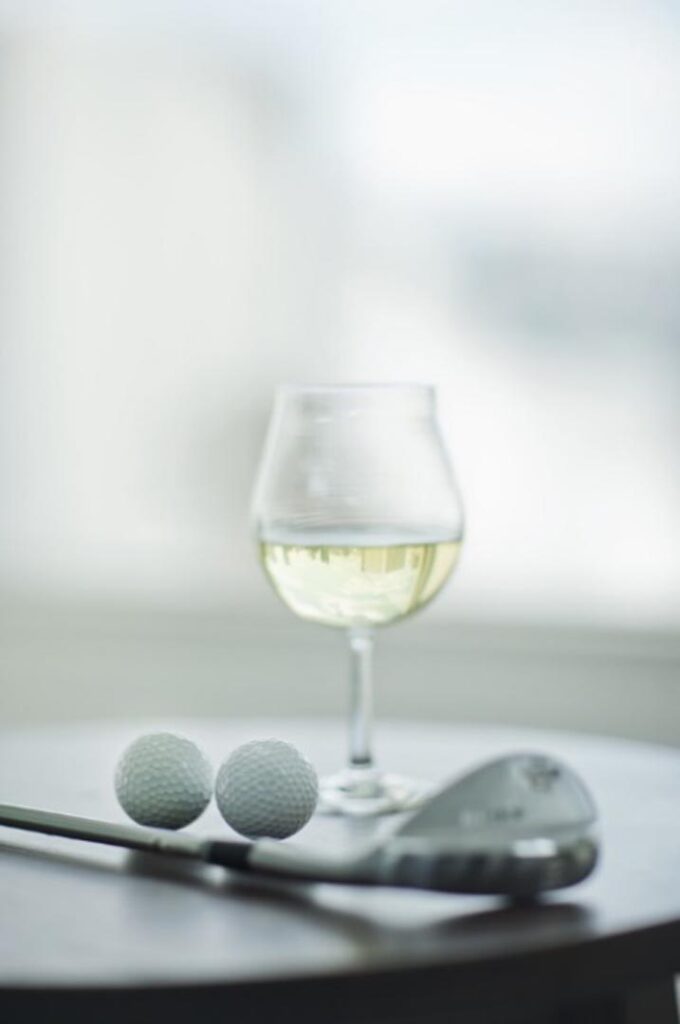 wine glass and golf club